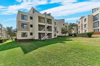 Exterior view of apartment complex with carports