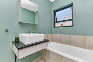 Bathroom with vessel basin and tub