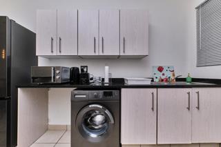 Kitchen with appliances and washing machine