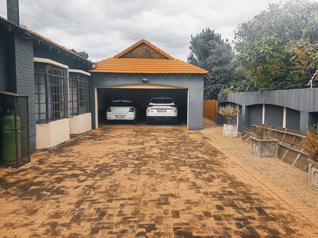 Paved driveway leading to double garage
