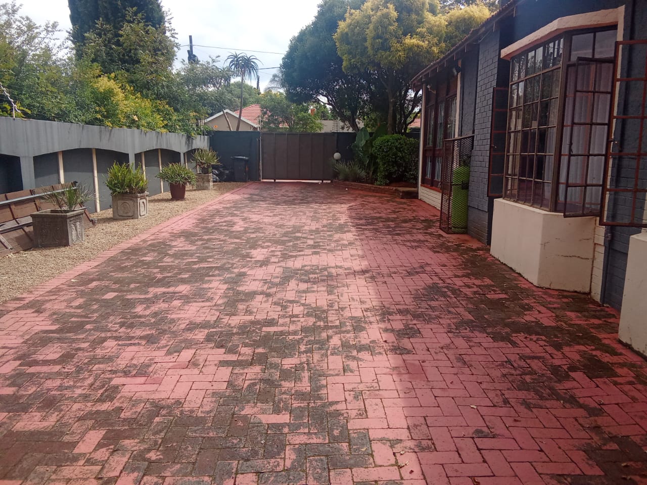 Long paved driveway alongside the house