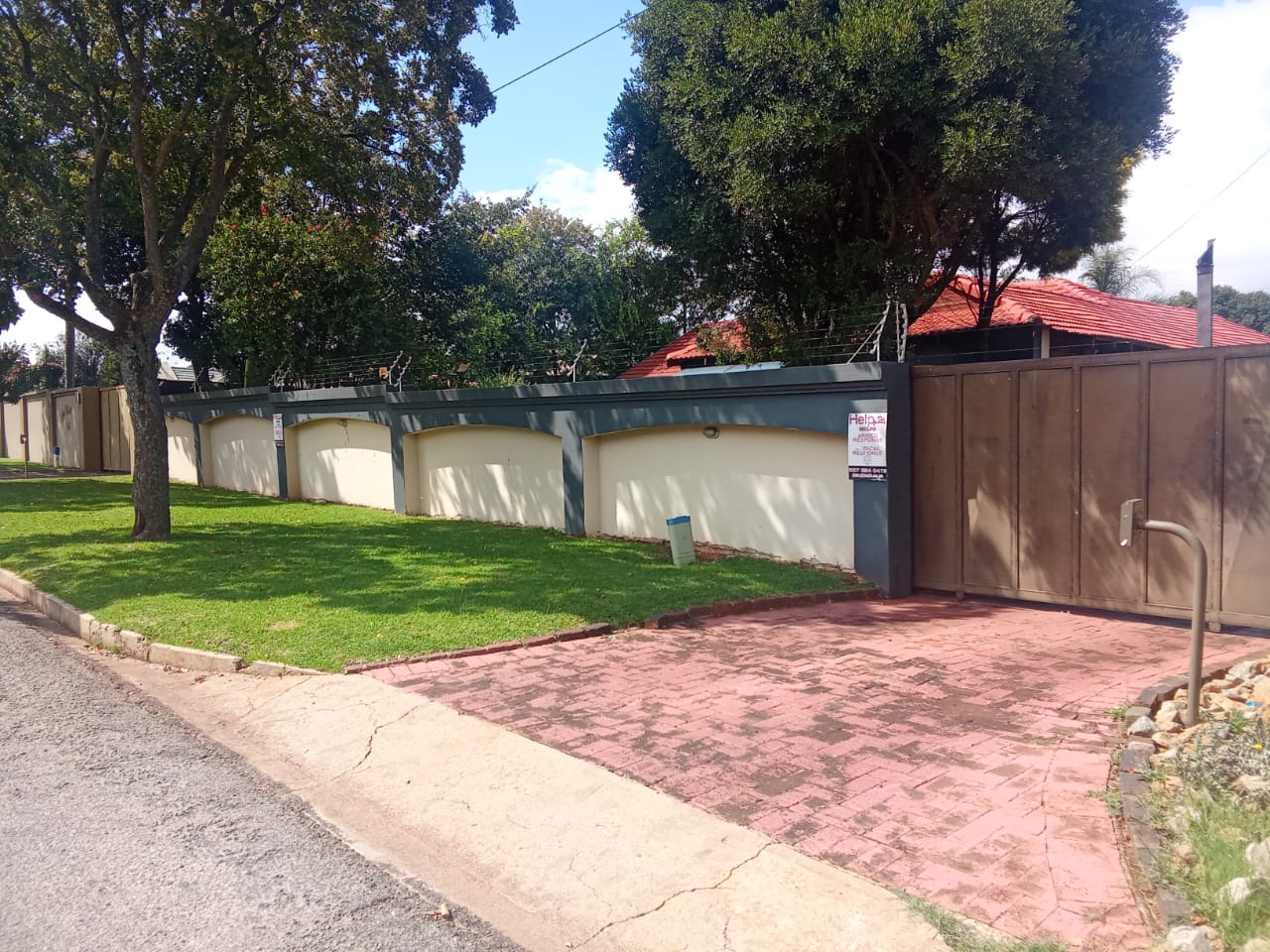 Street view with secure walled entrance and double gate