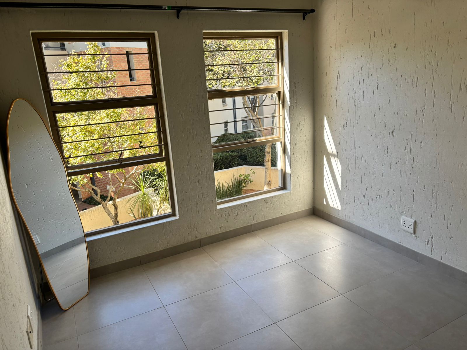 Furnished lounge with sectional sofa and balcony access